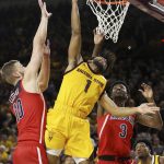 Arizona State guard Remy Martin (1) scores between Arizona forward Ryan Luther (10) and guard Dylan Smith (3) during the second half of an NCAA college basketball game Thursday, Jan. 31, 2019, in Tempe, Ariz. Arizona State won 95-88 in overtime. (AP Photo/Ross D. Franklin)