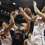 Arizona's Ryan Luther, center, fights for a rebound with Southern California's Bennie Boatwright, left, and Nick Rakocevic during the second half of an NCAA college basketball game Thursday, Jan. 24, 2019, in Los Angeles. USC won 80-57. (AP Photo/Jae C. Hong)