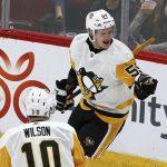 Pittsburgh Penguins left wing Jake Guentzel (59) celebrates his goal against the Arizona Coyotes with left wing Garrett Wilson (10) during the second period of an NHL hockey game Friday, Jan. 18, 2019, in Glendale, Ariz. (AP Photo/Ross D. Franklin)