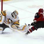 Pittsburgh Penguins goaltender Matt Murray (30) makes a save on a shot by Arizona Coyotes center Vinnie Hinostroza (13) during overtime in an NHL hockey game Friday, Jan. 18, 2019, in Glendale, Ariz. The Penguins won 3-2. (AP Photo/Ross D. Franklin)