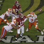 Alabama's Tua Tagovailoan throws under pressure during the second half of the NCAA college football playoff championship game against Clemson, Monday, Jan. 7, 2019, in Santa Clara, Calif. (AP Photo/Jeff Chiu)