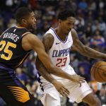 Phoenix Suns forward Mikal Bridges (25) knocks the ball away from LA Clippers guard Lou Williams in the first half during an NBA basketball game, Friday, Jan. 4, 2019, in Phoenix. (AP Photo/Rick Scuteri)