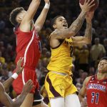 Arizona State guard Rob Edwards (2) slips past Arizona forward Ira Lee (11) and center Chase Jeter (4) to score during overtime of an NCAA college basketball game Thursday, Jan. 31, 2019, in Tempe, Ariz. Arizona State won 95-88. (AP Photo/Ross D. Franklin)