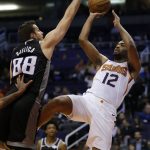 Phoenix Suns forward T.J. Warren (12) shoots over Sacramento Kings forward Nemanja Bjelica in the second half during an NBA basketball game, Tuesday, Jan. 8, 2019, in Phoenix. Phoenix defeated Sacramento 115-111. (AP Photo/Rick Scuteri)