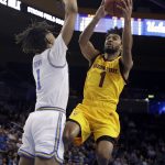 Arizona State's Remy Martin (1) drives to the basket as UCLA 's Moses Brown defends during the first half of an NCAA college basketball game Thursday, Jan. 24, 2019, in Los Angeles. (AP Photo/Marcio Jose Sanchez)