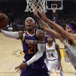 Phoenix Suns forward Richaun Holmes, left, shoos as Los Angeles Lakers center JaVale McGee defends during the first half of an NBA basketball game Sunday, Jan. 27, 2019, in Los Angeles. (AP Photo/Mark J. Terrill)