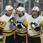 Pittsburgh Penguins right wing Phil Kessel (81) celebrates his overtime goal against the Arizona Coyotes with center Sidney Crosby (87) and defenseman Kris Letang (58) in an NHL hockey game Friday, Jan. 18, 2019, in Glendale, Ariz. The Penguins won 3-2. (AP Photo/Ross D. Franklin)