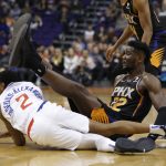 Phoenix Suns center Deandre Ayton (22) trips over Los Angeles Clippers guard Shai Gilgeous-Alexander in the second half during an NBA basketball game, Friday, Jan. 4, 2019, in Phoenix.  (AP Photo/Rick Scuteri)