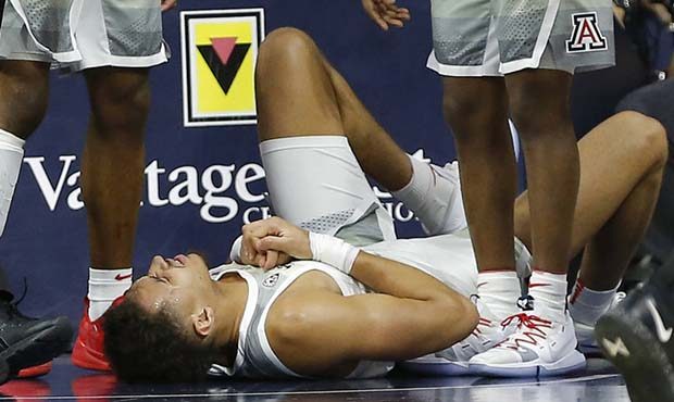 Arizona center Chase Jeter reacts after falling to the court during the first half of the team's NC...