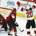 New Jersey Devils center Blake Coleman (20) celebrates his goal with Devils center Travis Zajac, right, as Arizona Coyotes goaltender Darcy Kuemper (35) and defenseman Alex Goligoski (33) look for the puck during the second period of an NHL hockey game Friday, Jan. 4, 2019, in Glendale, Ariz. (AP Photo/Ross D. Franklin)