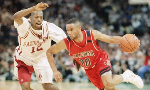 Arizona?s Damon Stoudamire, sporting a tattoo on his shoulder, drives to the hoop past Arkansas? Cl...