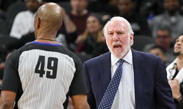 San Antonio Spurs coach Gregg Popovich, right, yells to referee Tom Washington during the second ha...