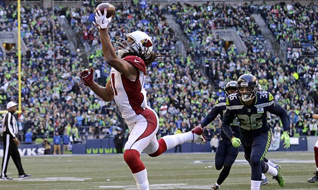 Arizona Cardinals' Larry Fitzgerald, left, snags a one-handed touchdown pass against the Seattle Se...