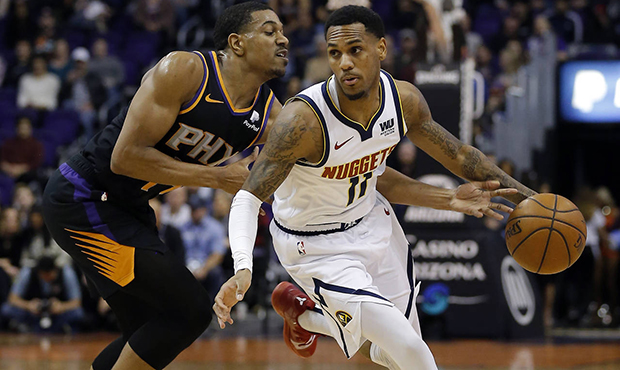 Denver Nuggets guard Monte Morris (11) drives past Phoenix Suns guard De'Anthony Melton during the ...