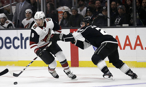 Arizona Coyotes' Nick Schmaltz (8) is defended by Los Angeles Kings' Alec Martinez during the first...