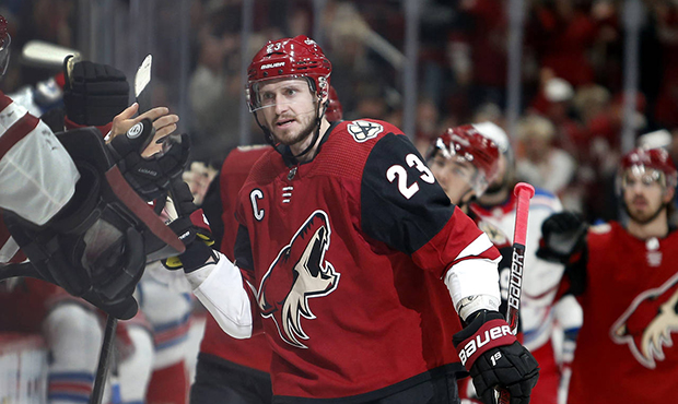 Arizona Coyotes defenseman Oliver Ekman-Larsson (23) is congratulated by teammates after scoring a ...