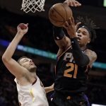 Phoenix Suns' Richaun Holmes, right, and Cleveland Cavaliers' Ante Zizic, from Croatia, battle for a rebound in the first half of an NBA basketball game, Thursday, Feb. 21, 2019, in Cleveland. (AP Photo/Tony Dejak)