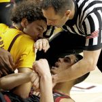 A referee breaks up a scuffle between Arizona State forward Taeshon Cherry, left, and Stanford forward Jaiden Delaire during the first half of an NCAA college basketball game Wednesday, Feb. 20, 2019, in Tempe, Ariz. (AP Photo/Rick Scuteri)