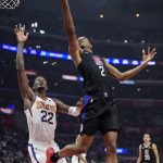 Los Angeles Clippers guard Shai Gilgeous-Alexander, right, shoots as Phoenix Suns center Deandre Ayton defends during the first half of an NBA basketball game Wednesday, Feb. 13, 2019, in Los Angeles. (AP Photo/Mark J. Terrill)