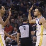 Golden State Warriors guard Stephen Curry, right, high-fives guard Shaun Livingston, left, during the second half of the team's NBA basketball game against the Phoenix Suns on Friday, Feb. 8, 2019, in Phoenix. The Warriors won 117-107. (AP Photo/Ross D. Franklin)