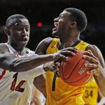 California guard Darius McNeill is defended by Arizona guard Justin Coleman (12) during the first half of pan NCAA college basketball game Thursday, Feb. 21, 2019, in Tucson, Ariz. (AP Photo/Rick Scuteri)