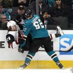 Arizona Coyotes right wing Mario Kempe (29) is checked into the boards by San Jose Sharks right wing Kevin Labanc (62) during the first period of an NHL hockey game in San Jose, Calif., Saturday, Feb. 2, 2019. (AP Photo/Tony Avelar)