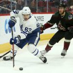 Toronto Maple Leafs left wing Tyler Ennis (63) tries to circle around to shoot as Arizona Coyotes defenseman Jordan Oesterle (82) applies pressure during the first period of an NHL hockey game Saturday, Feb. 16, 2019, in Glendale, Ariz. (AP Photo/Ross D. Franklin)