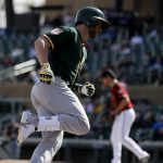 Oakland Athletics' Dustin Fowler, foreground, rounds the bases after a home run off Arizona Diamondbacks relief pitcher Matt Andriese during the fourth inning of a spring baseball game in Scottsdale, Ariz., Monday, Feb. 25, 2019. (AP Photo/Chris Carlson)