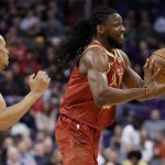Houston Rockets forward Kenneth Faried bobbles the ball as Phoenix Suns guard Elie Okobo (2) defends during the first half of an NBA basketball game,, Monday, Feb. 4, 2019, in Phoenix. (AP Photo/Matt York)
