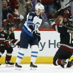 Arizona Coyotes center Brad Richardson (15) celebrates his goal against the Winnipeg Jets with Coyotes' Vinnie Hinostroza (13) as Jets center Bryan Little (18) skates past during the first period of an NHL hockey game Sunday, Feb. 24, 2019, in Glendale, Ariz. (AP Photo/Ross D. Franklin)