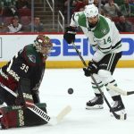 Arizona Coyotes goaltender Darcy Kuemper (35) makes a save on a shot as Dallas Stars left wing Jamie Benn (14) looks for a possible rebound during the first period of an NHL hockey game Saturday, Feb. 9, 2019, in Glendale, Ariz. (AP Photo/Ross D. Franklin)