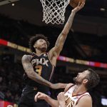Phoenix Suns' Kelly Oubre Jr. (3) drives to the basket against Cleveland Cavaliers' Kevin Love (0) in the second half of an NBA basketball game, Thursday, Feb. 21, 2019, in Cleveland. (AP Photo/Tony Dejak)