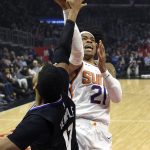 Phoenix Suns forward Richaun Holmes, right, shoots as Los Angeles Clippers guard Garrett Temple defends during the first half of an NBA basketball game Wednesday, Feb. 13, 2019, in Los Angeles. (AP Photo/Mark J. Terrill)