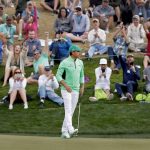 Fans cheer as Rickie Fowler makes his birdie putt on the sixth green during the third round of the Phoenix Open PGA golf tournament, Saturday, Feb. 2, 2019, in Scottsdale, Ariz. (AP Photo/Matt York)