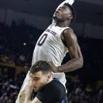 Arizona State's Luguentz Dort (0) goes up and over Washington's Sam Timmins (33) during the second half of an NCAA college basketball game Saturday, Feb. 9, 2019, in Tempe, Ariz. Arizona State won 75-63. (AP Photo/Darryl Webb)