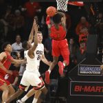 Arizona's Devonaire Doutrive (1) scores off a rebound in the final second of the game, getting past Oregon State's Alfred Hollins (4) and Kylor Kelley (24), to secure the win during an NCAA college basketball game in Corvallis, Ore., Thursday, Feb. 28, 2019. Arizona won 74-72. (AP Photo/Amanda Loman)