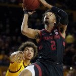 Stanford guard Bryce Wills (2) drives past Arizona State forward Taeshon Cherry during the first half of an NCAA college basketball game Wednesday, Feb. 20, 2019, in Tempe, Ariz. (AP Photo/Rick Scuteri)