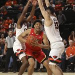 Arizona's Ira Lee (11) fights through Oregon State's Alfred Hollins (4), left, and Gligorije Rakocevic (23), right, during the first half of an NCAA college basketball game in Corvallis, Ore., Thursday, Feb. 28, 2019. (AP Photo/Amanda Loman)