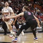 Phoenix Suns guard Tyler Johnson (16) reacts to a foul from Miami Heat forward Kelly Olynyk (9) during the first half of an NBA basketball game Monday, Feb. 25, 2019, in Miami. (AP Photo/Brynn Anderson)