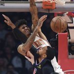 Phoenix Suns forward Kelly Oubre Jr. dunks over Los Angeles Clippers guard Garrett Temple during the first half of an NBA basketball game Wednesday, Feb. 13, 2019, in Los Angeles. (AP Photo/Mark J. Terrill)