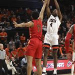 Oregon State's Alfred Hollins (4) takes a shot despite defense from Arizona's Ira Lee (11) during the first half of an NCAA college basketball game in Corvallis, Ore., Thursday, Feb. 28, 2019. (AP Photo/Amanda Loman)