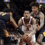 Cleveland Cavaliers' Jordan Clarkson (8) drives between Phoenix Suns' Richaun Holmes (21) and Kelly Oubre Jr. (3) in the first half of an NBA basketball game, Thursday, Feb. 21, 2019, in Cleveland. (AP Photo/Tony Dejak)