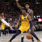 Utah Jazz's Donovan Mitchell (45) looks for an opening as Phoenix Suns' Kelly Oubre Jr., back, defends during the second half of an NBA basketball game Wednesday, Feb. 6, 2019, in Salt Lake City. (AP Photo/Kim Raff)