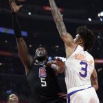 Los Angeles Clippers forward Montrezl Harrell, center, shoots as Phoenix Suns forward Kelly Oubre Jr., right, defends and guard Jamal Crawford watches during the first half of an NBA basketball game Wednesday, Feb. 13, 2019, in Los Angeles. (AP Photo/Mark J. Terrill)