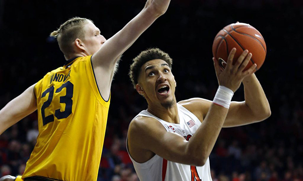 Arizona center Chase Jeter (4) drives on California center Connor Vanover during the second half of...