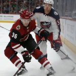 Arizona Coyotes right wing Christian Fischer (36) shields Columbus Blue Jackets left wing Markus Hannikainen from the puck in the first period during an NHL hockey game, Thursday, Feb. 7, 2019, in Glendale, Ariz. (AP Photo/Rick Scuteri)