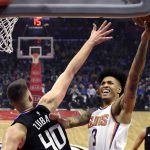 Phoenix Suns forward Kelly Oubre Jr., center, shoots as Los Angeles Clippers center Ivica Zubac, left, defends and guard Landry Shamet watches during the first half of an NBA basketball game Wednesday, Feb. 13, 2019, in Los Angeles. (AP Photo/Mark J. Terrill)