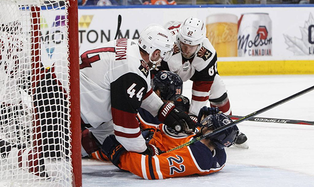Arizona Coyotes' Kevin Connauton (44) and Jordan Oesterle (82) protect the net from Edmonton Oilers...