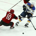 St. Louis Blues defenseman Vince Dunn (29) passes the puck as Arizona Coyotes center Jordan Weal (10) defends during the third period of an NHL hockey game Thursday, Feb. 14, 2019, in Glendale, Ariz. The Blues defeated the Coyotes 4-0. (AP Photo/Ross D. Franklin)