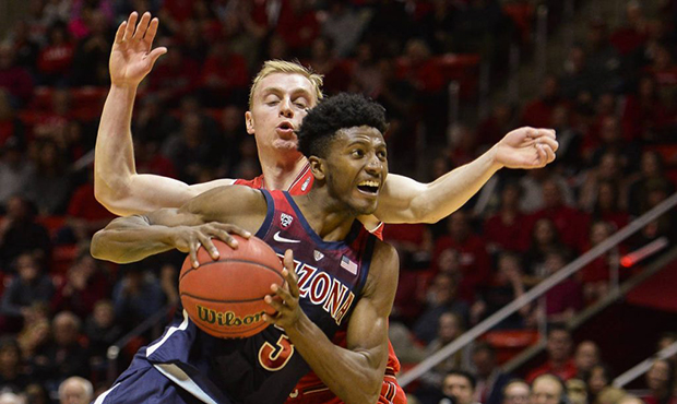 Arizona guard Dylan Smith, front, attempts to drive past Utah guard Parker Van Dyke, rear, during t...